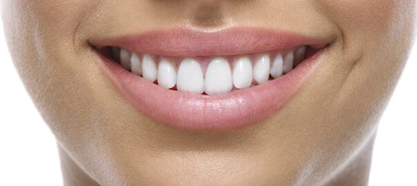 Close-up of a smiling woman's mouth.