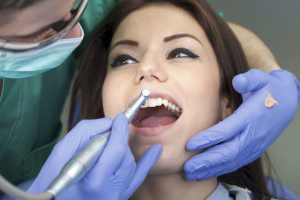 Dental procedure with patient and dentist.