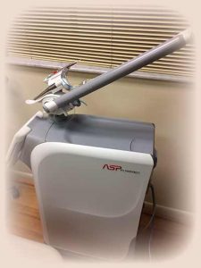 A white and gray machine sitting on top of a wooden floor.